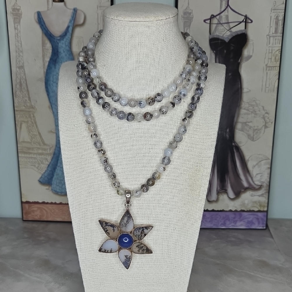 Dendritic agate beads with a starburst and a silver pendant. 22" Drop